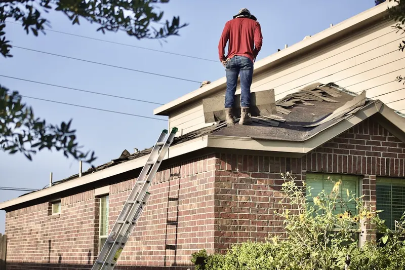 Professional roofer working on a residential roof in Mayflower Village